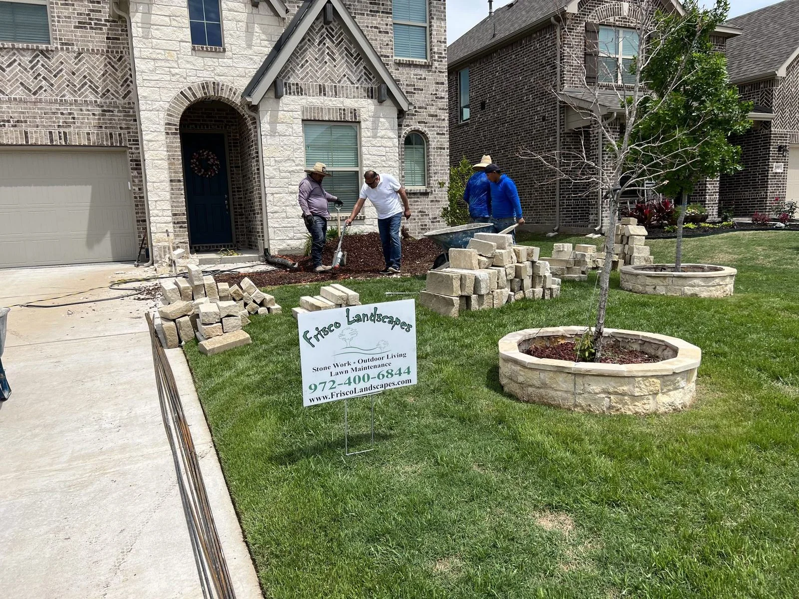 Frisco Landscapes crew building natural stone tree rings in a Plano, TX front yard