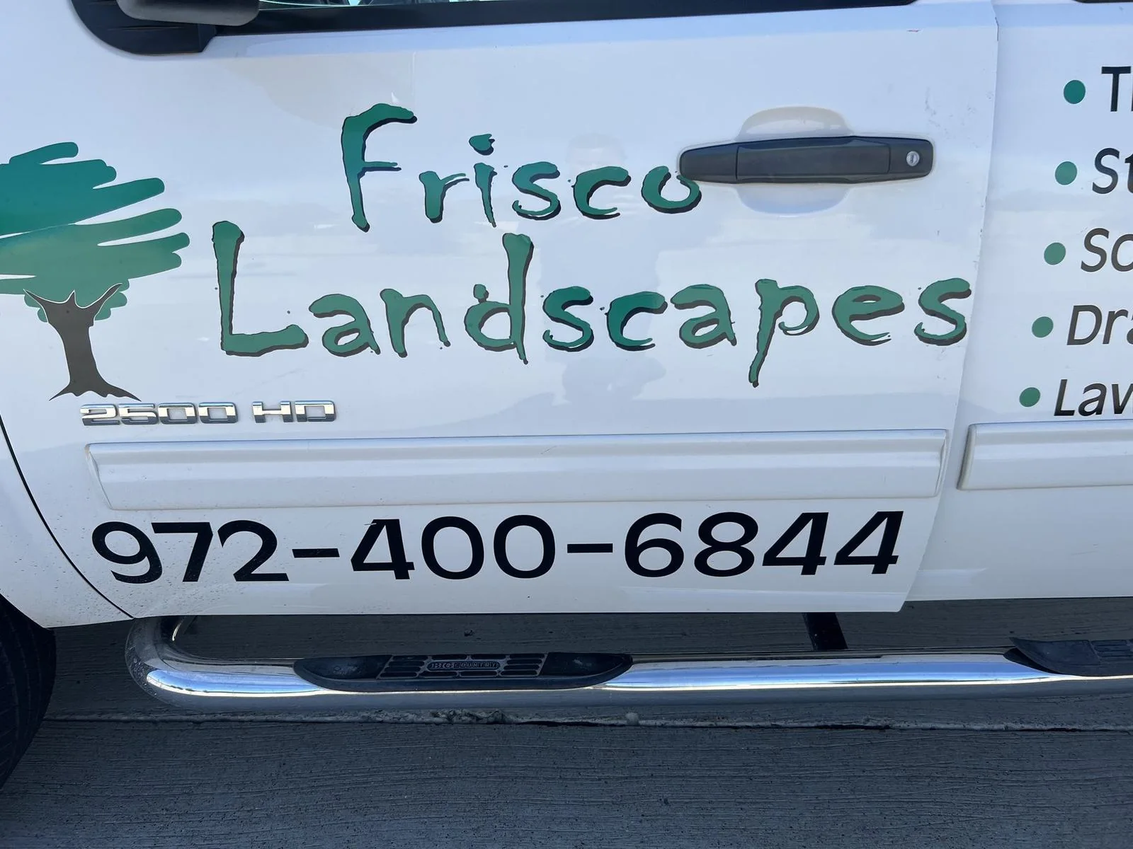 Frisco Landscapes local Plano, TX service truck with the company name and phone number