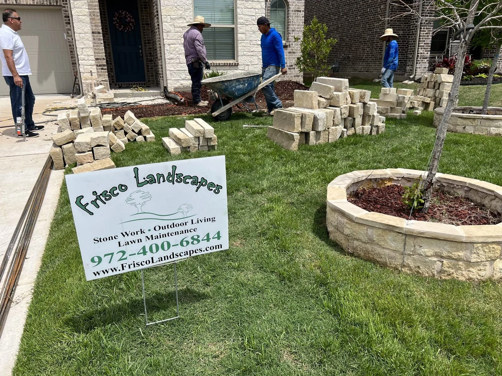 Finished natural stone tree ring with fresh mulch by Frisco Landscapes in Plano, TX